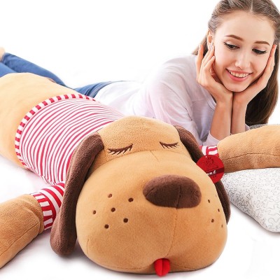 Stuffed toy dog, baby girl's birthday present sleeping on the pillow